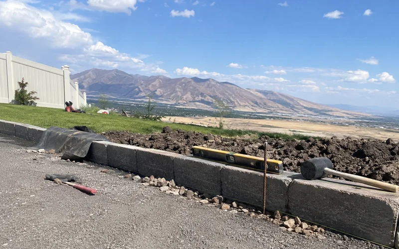 Base course of a retaining wall being set on compacted road base