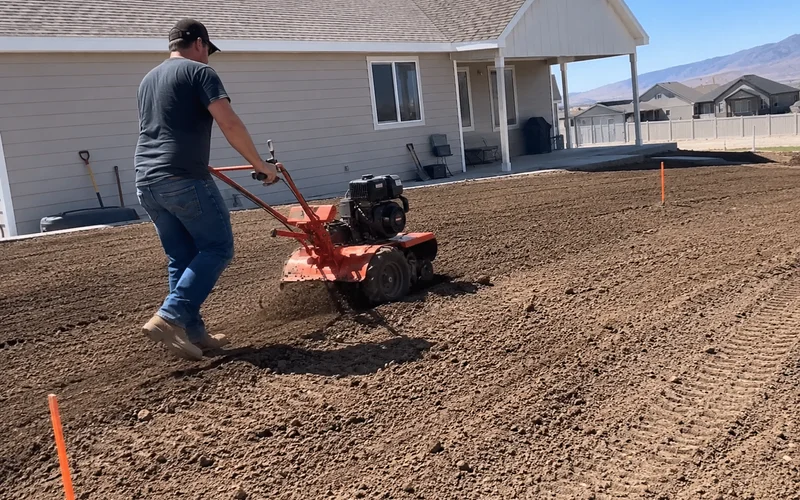Rototiller working screened topsoil into a new-construction Utah yard