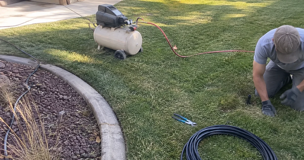 Air compressor connected to a residential sprinkler system for a fall blowout in a Utah yard
