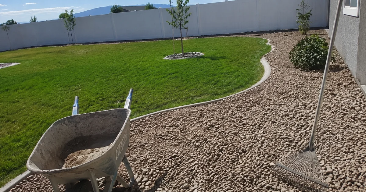 A finished new-build Utah yard with lawn, young trees and edged gravel beds