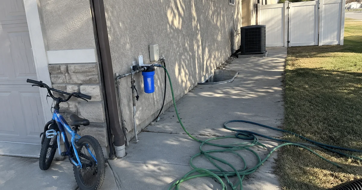 Secondary water connection with a filter canister and pressure reducer in a Utah side yard