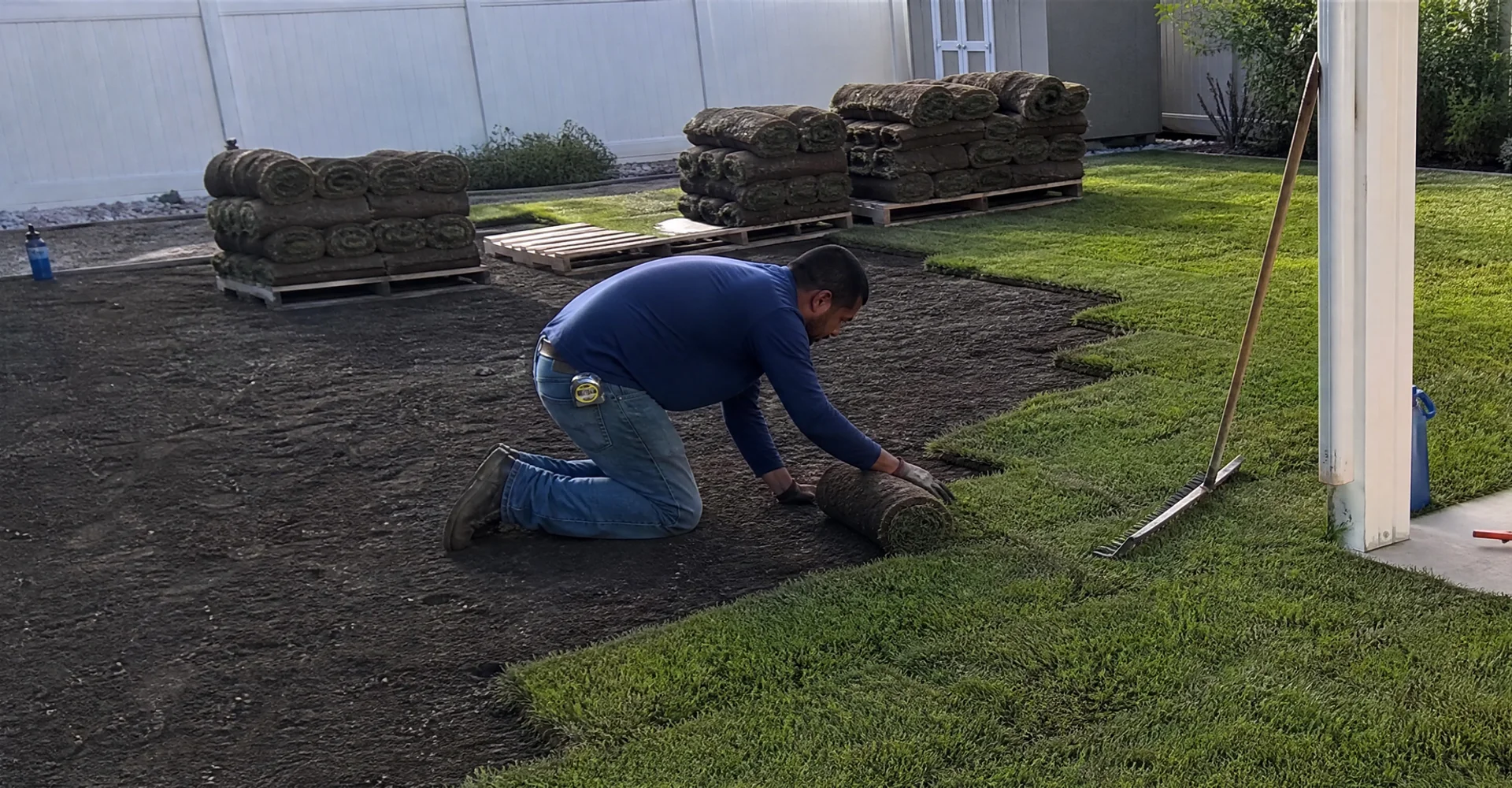 Fresh sod being laid edge to edge across a prepped and graded Utah yard