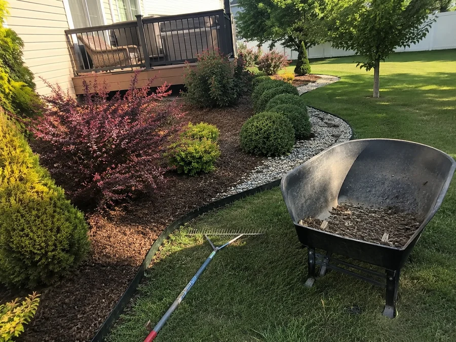 A maintained Utah landscape with crisp bed lines, healthy shrubs and a clean gravel border