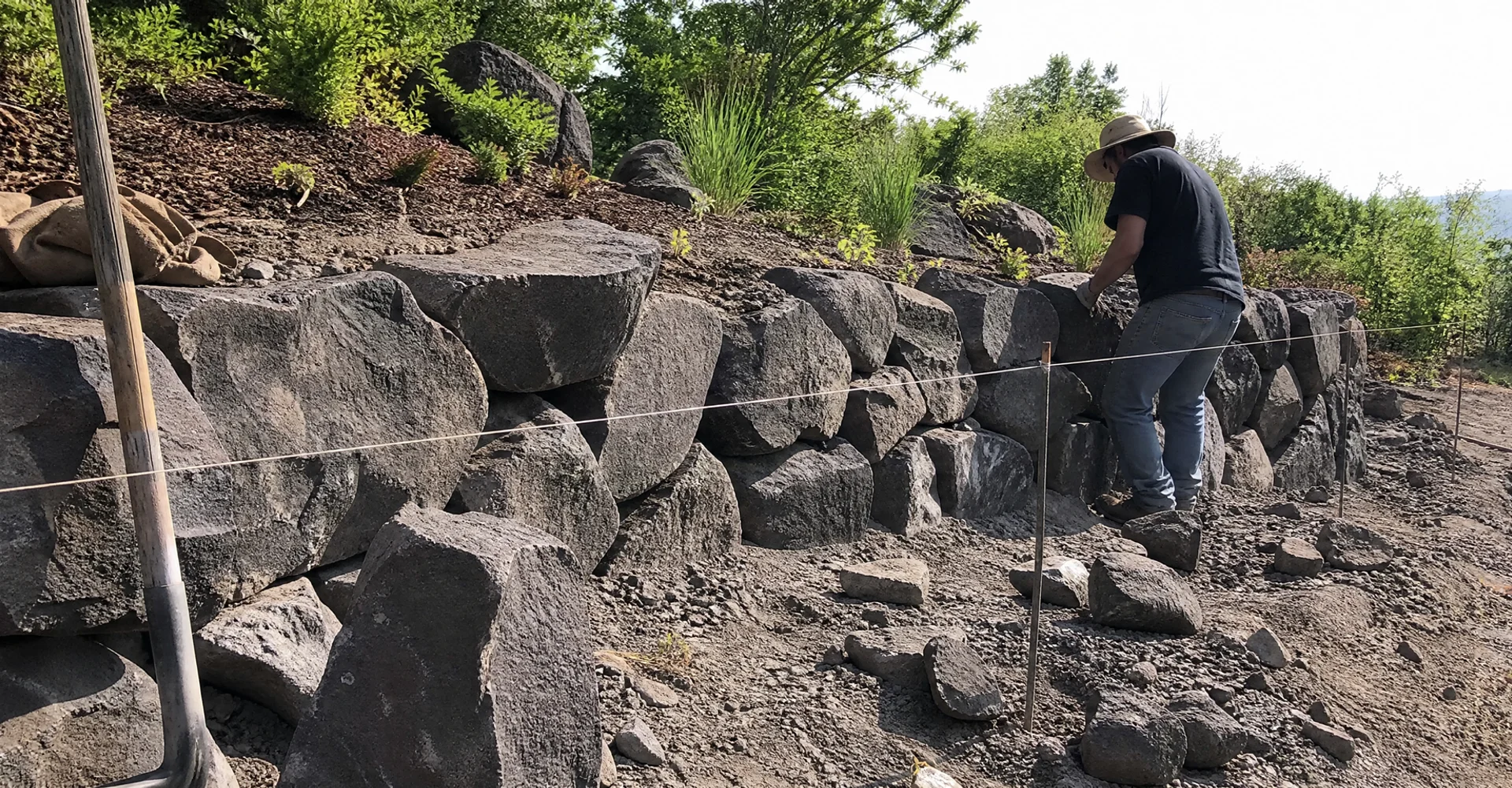 Natural basalt boulder wall running through a rural Utah landscape