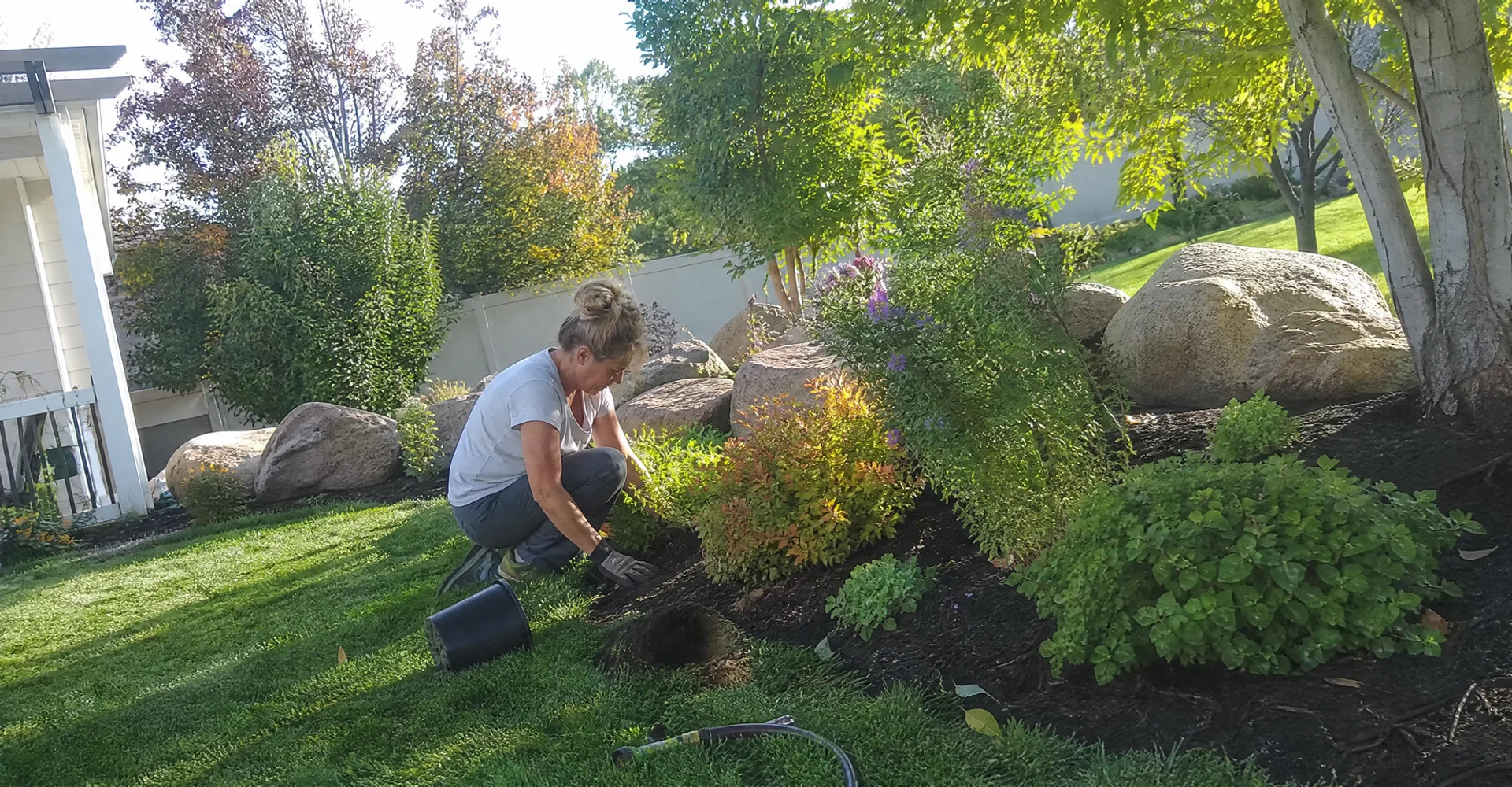 A well-kept Utah yard with trimmed beds, clean edges and healthy planting in early fall